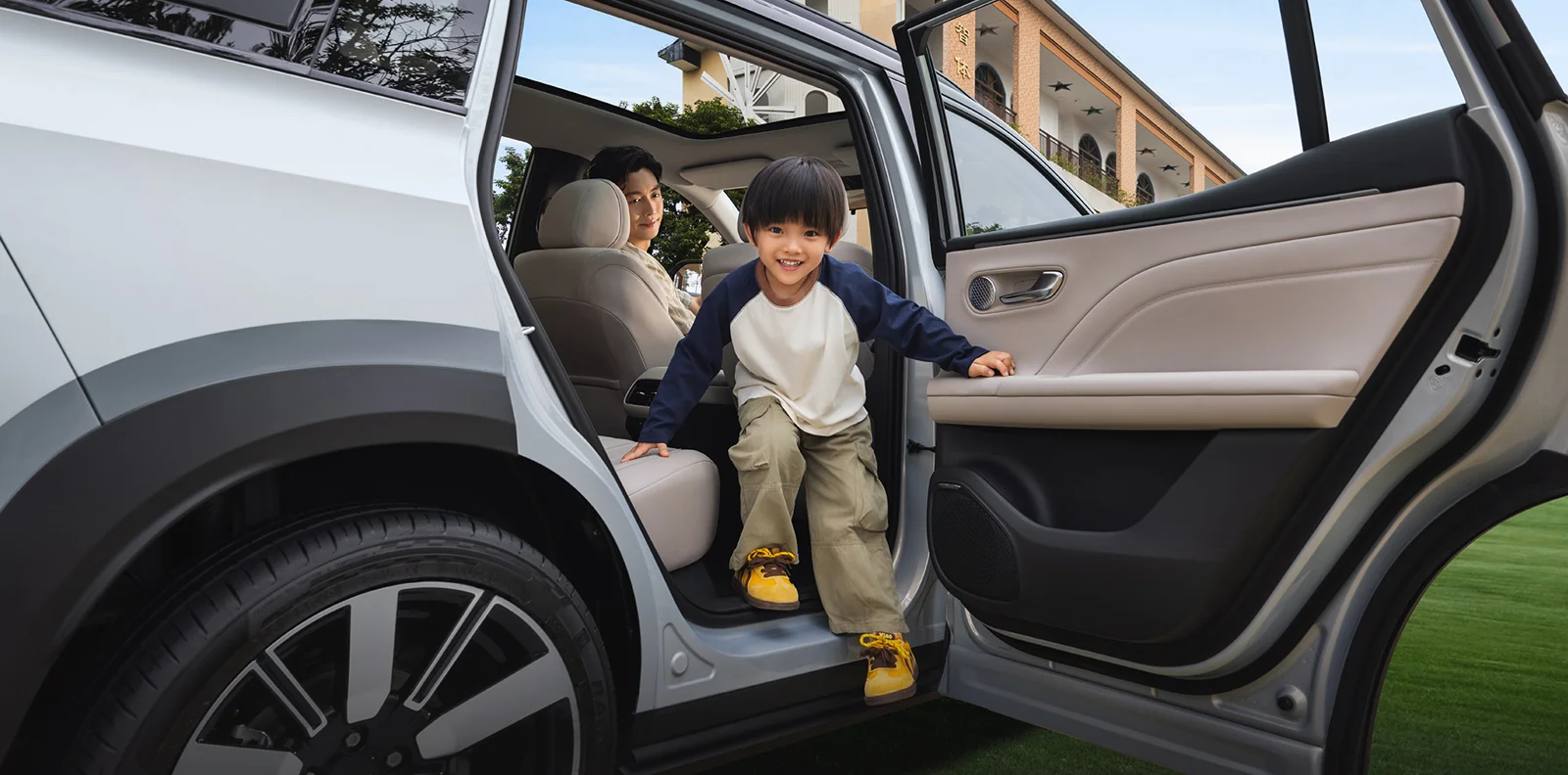 AION i60 rear passenger access shown in a manufacturer lifestyle image